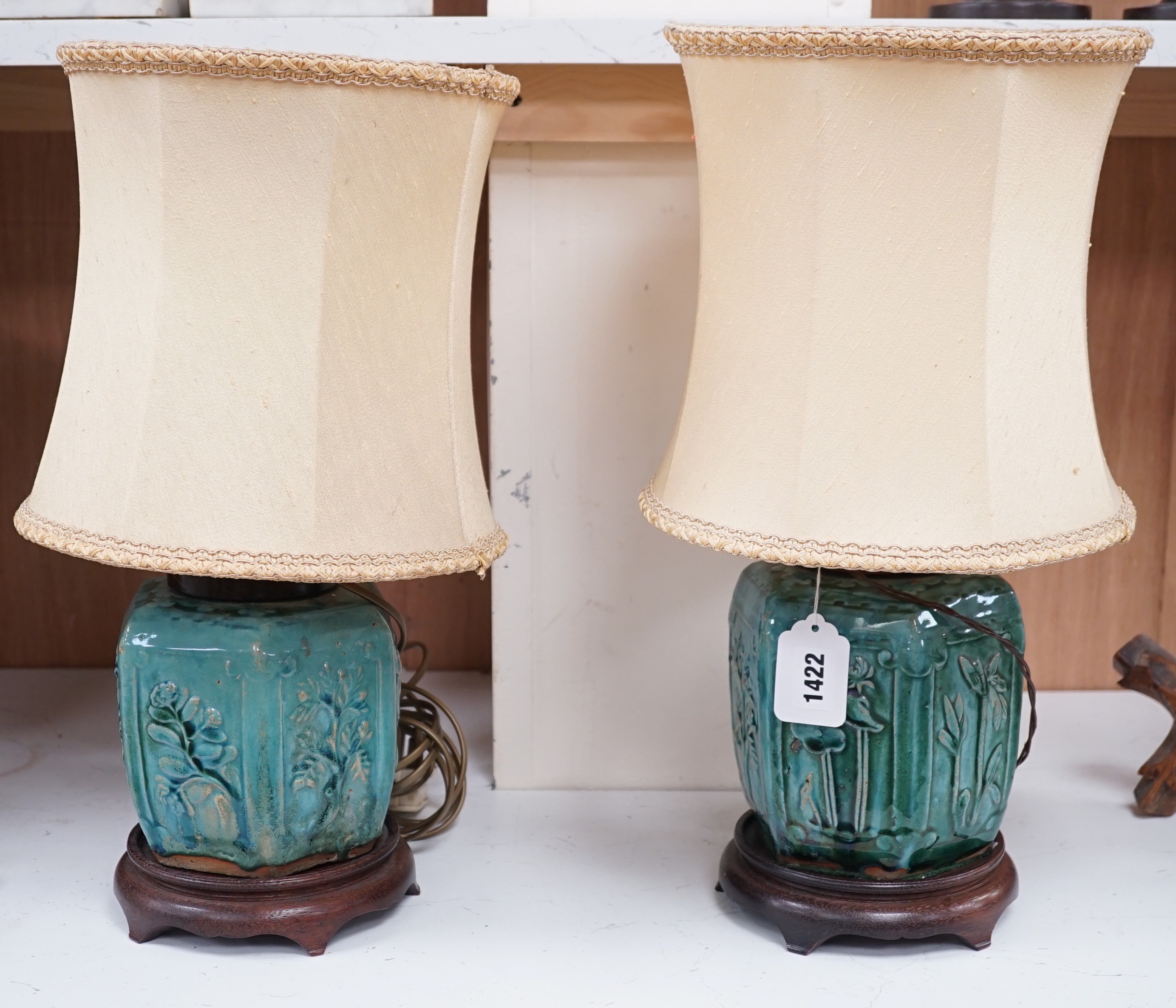 A pair of Chinese blue glazed earthenware hexagonal vase lamps on wooden mounts, with their shades. 45cm tall overall